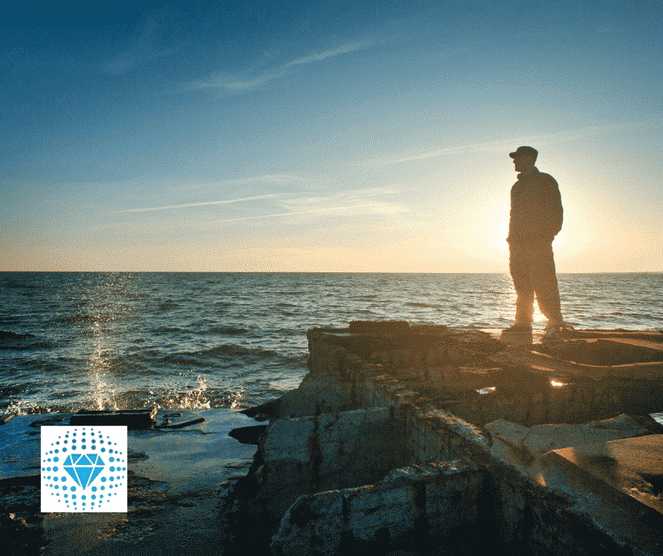 man looking over ocean, thinking