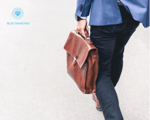 man walking with briefcase with blue diamond logo