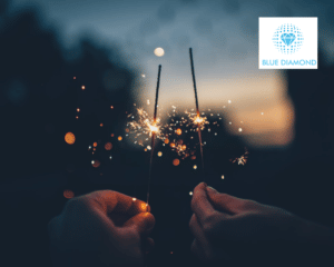 Sparklers lit and bright with sparks flying to symbolise sparks of ideas with blue diamond logo