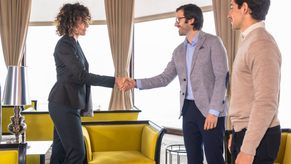 How to Progress in Your Finance Career: From Technical Expert to Leader Finance professional shaking hands with an executive to secure a career promotion.