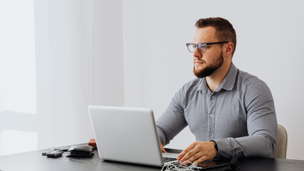 How to Progress in Your Finance Career: From Technical Expert to Leader Finance professional taking a reflective pause at a desk when experiencing a career plateau.