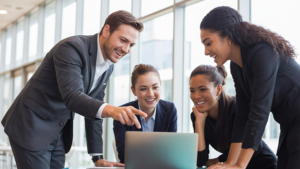 An image of a vibrant finance team actively collaborating on a project which is symbolising team leadership.