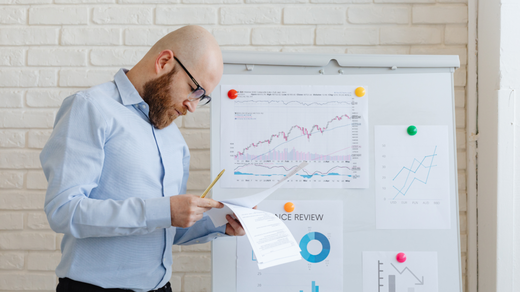 A finance team leader struggling to communicate a project to his team, symbolising the disconnect between technical and people skills.